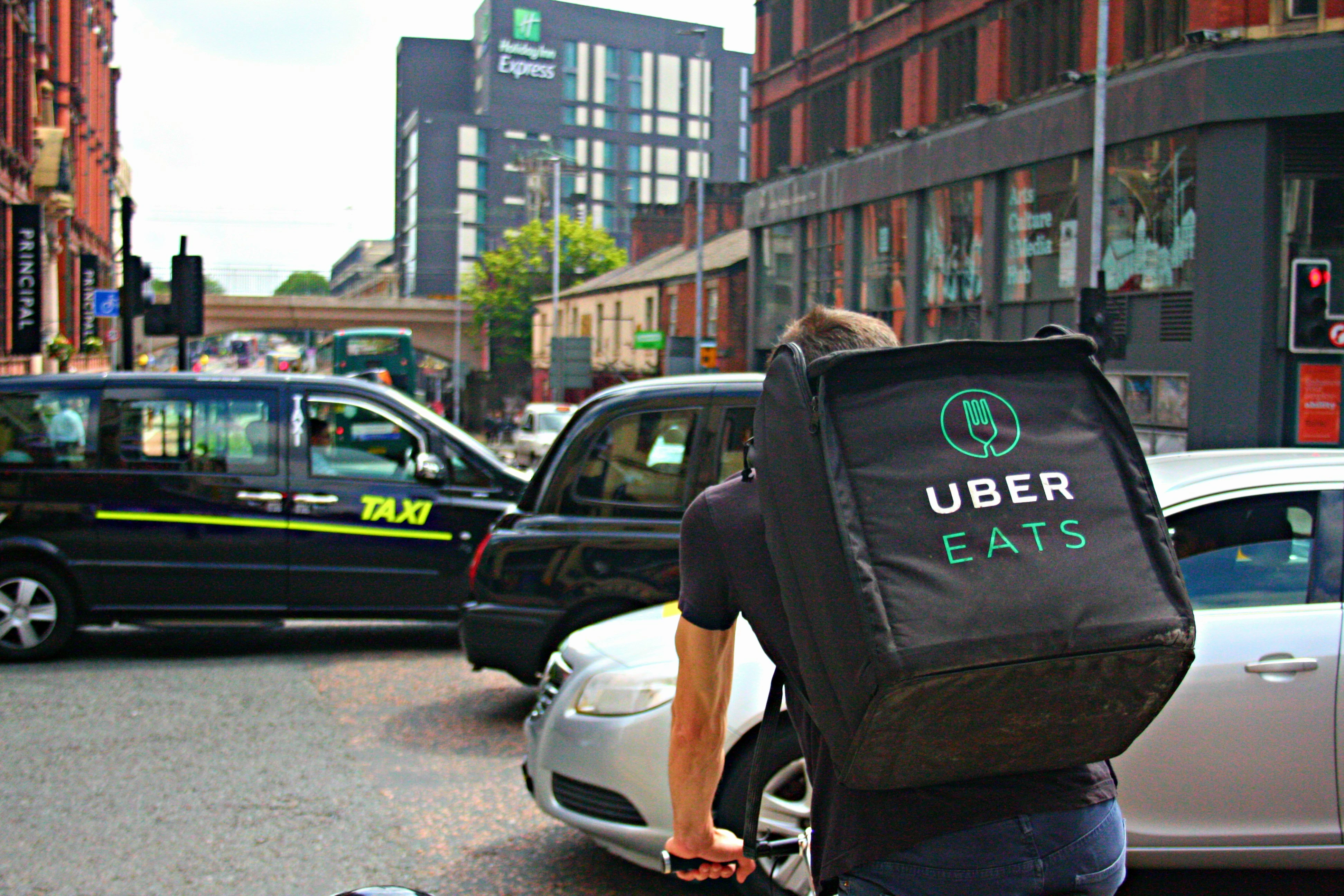 UBER Eats Delivery Cyclist Riding Through a Busy Oxford Road in Manchester