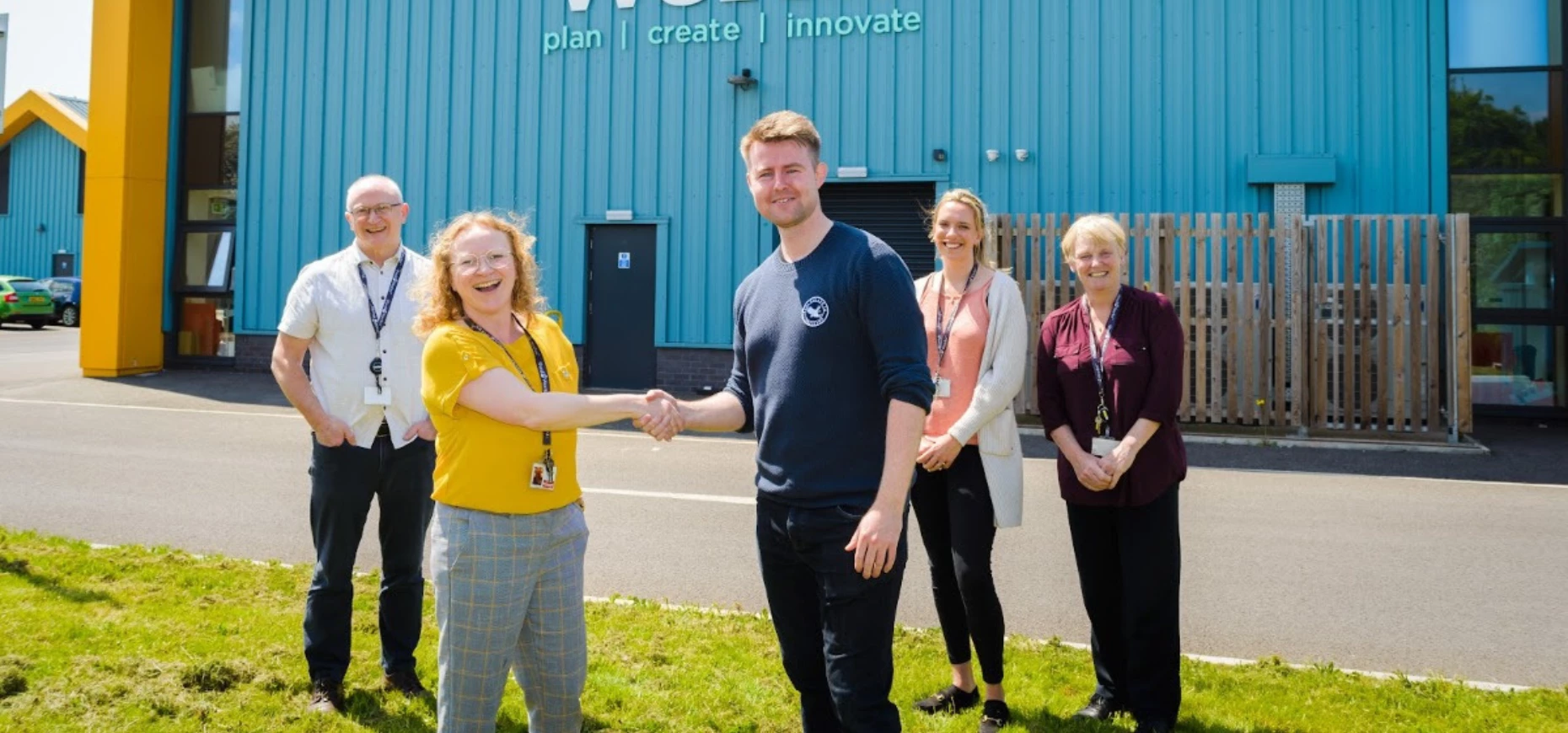 Alex Williams shaking the hand of NPD and Innovation Manager Zoe Plant with the team outside The Food WorksSW.