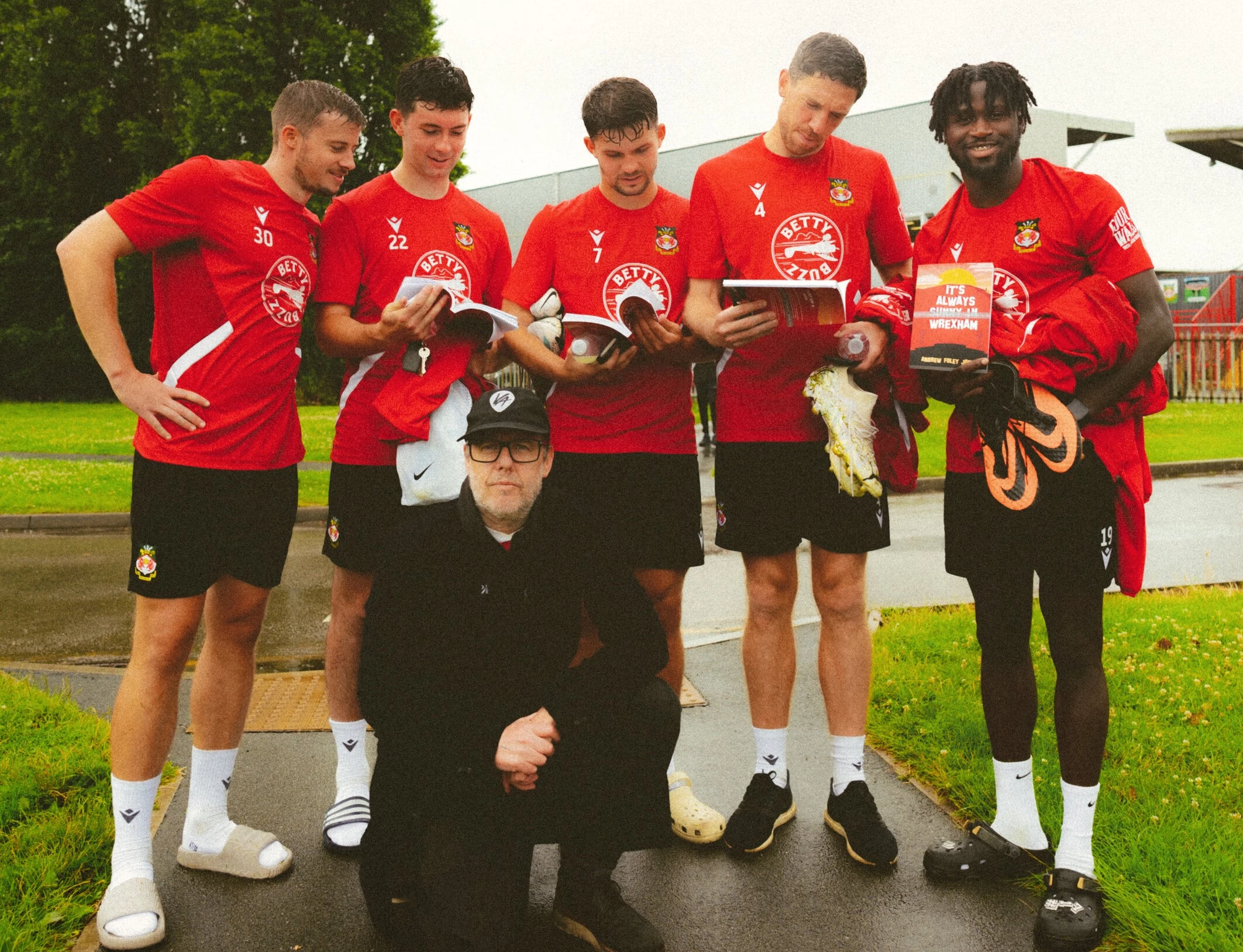 Andrew Foley Jones with Wrexham AFC players and his new book