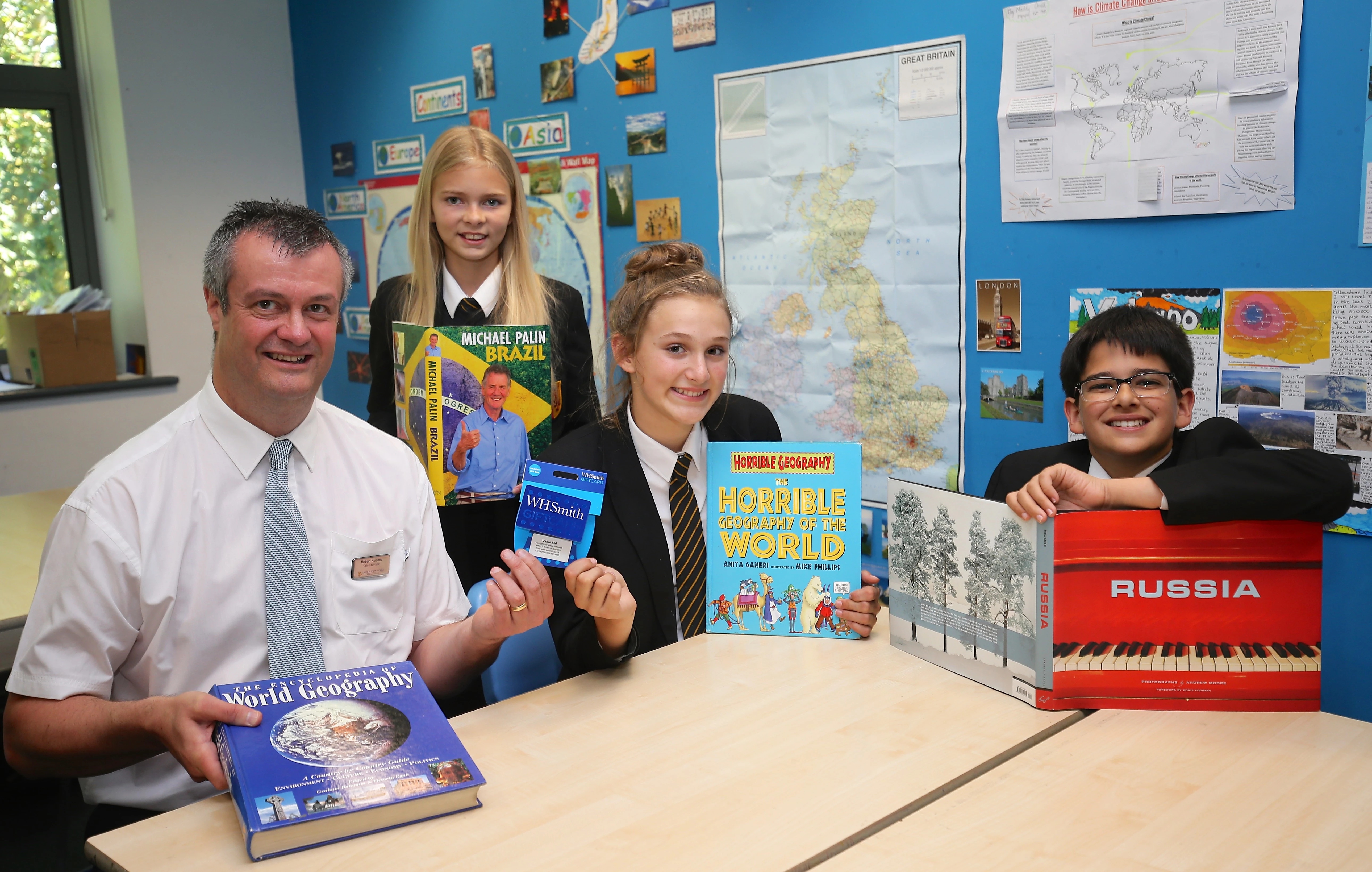 Sales adviser Rob Kissane from David Wilson Homes presents a selection of new books to Emily Hounsell, Megan Logsdon and Jack Davey