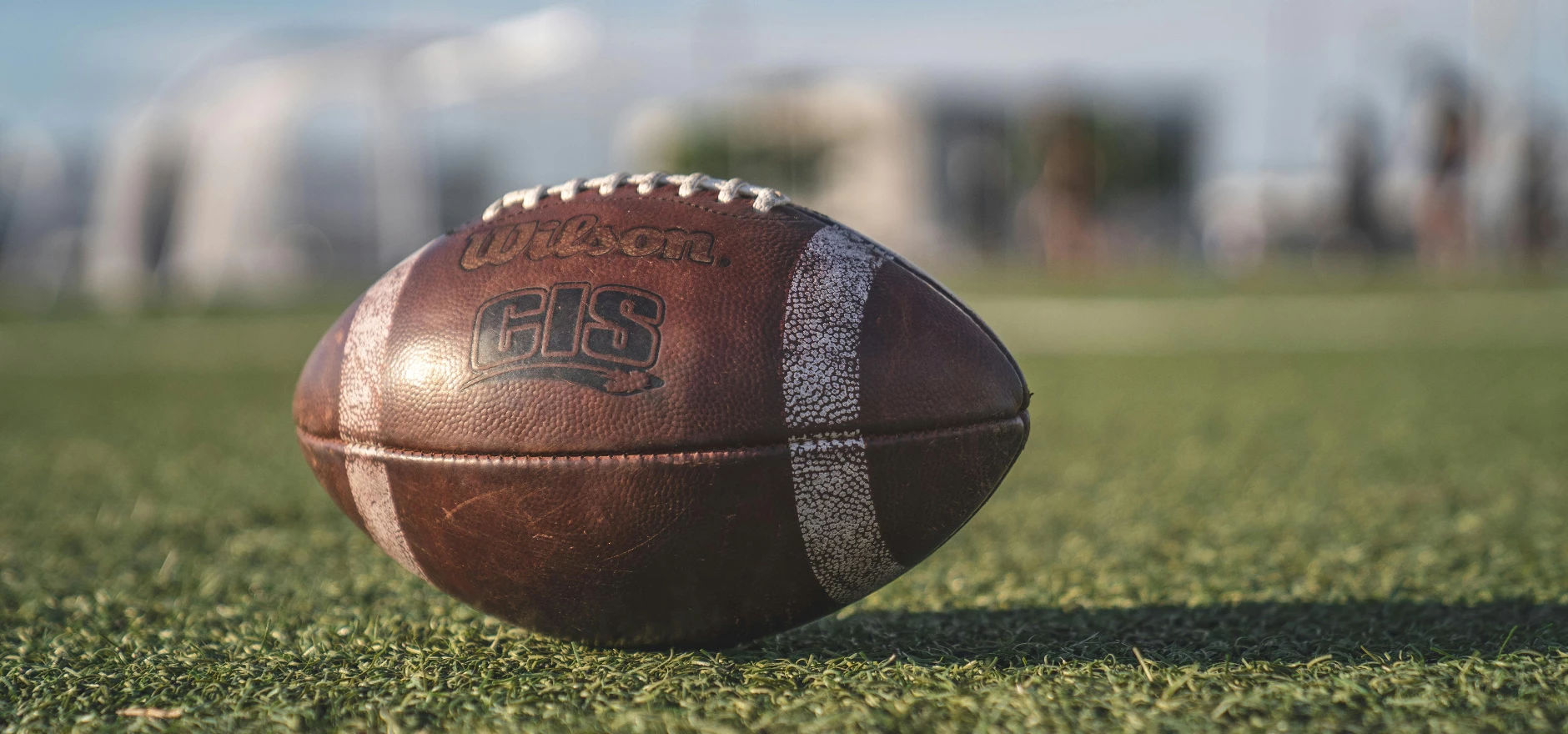 Selective Focus Close-up Photo of Brown Wilson Pigskin Football on Green Grass