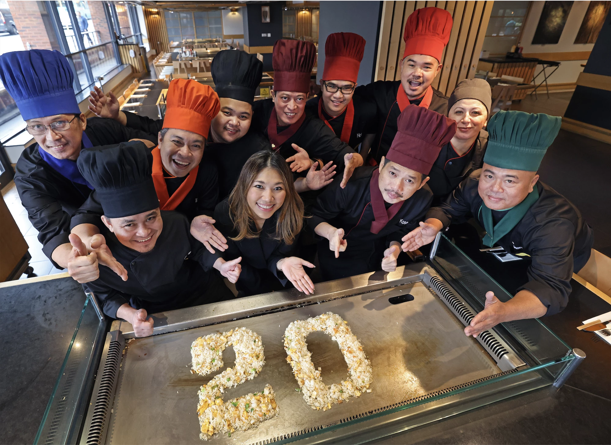 Sapporo Teppanyaki Liverpool are celebrating their 20th anniversary. Pictured: Jesney Chong, General Manager, with chefs at Sapporo Teppanyaki.