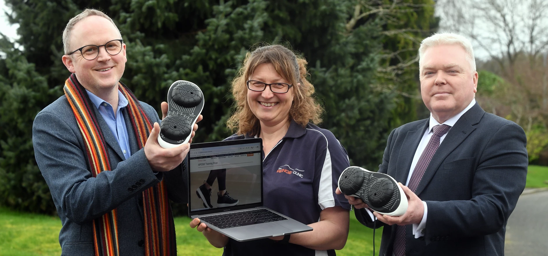 From left: Steve Tipson, Gina Reinge and Cllr Martin Watson with a pair of Apos shoes