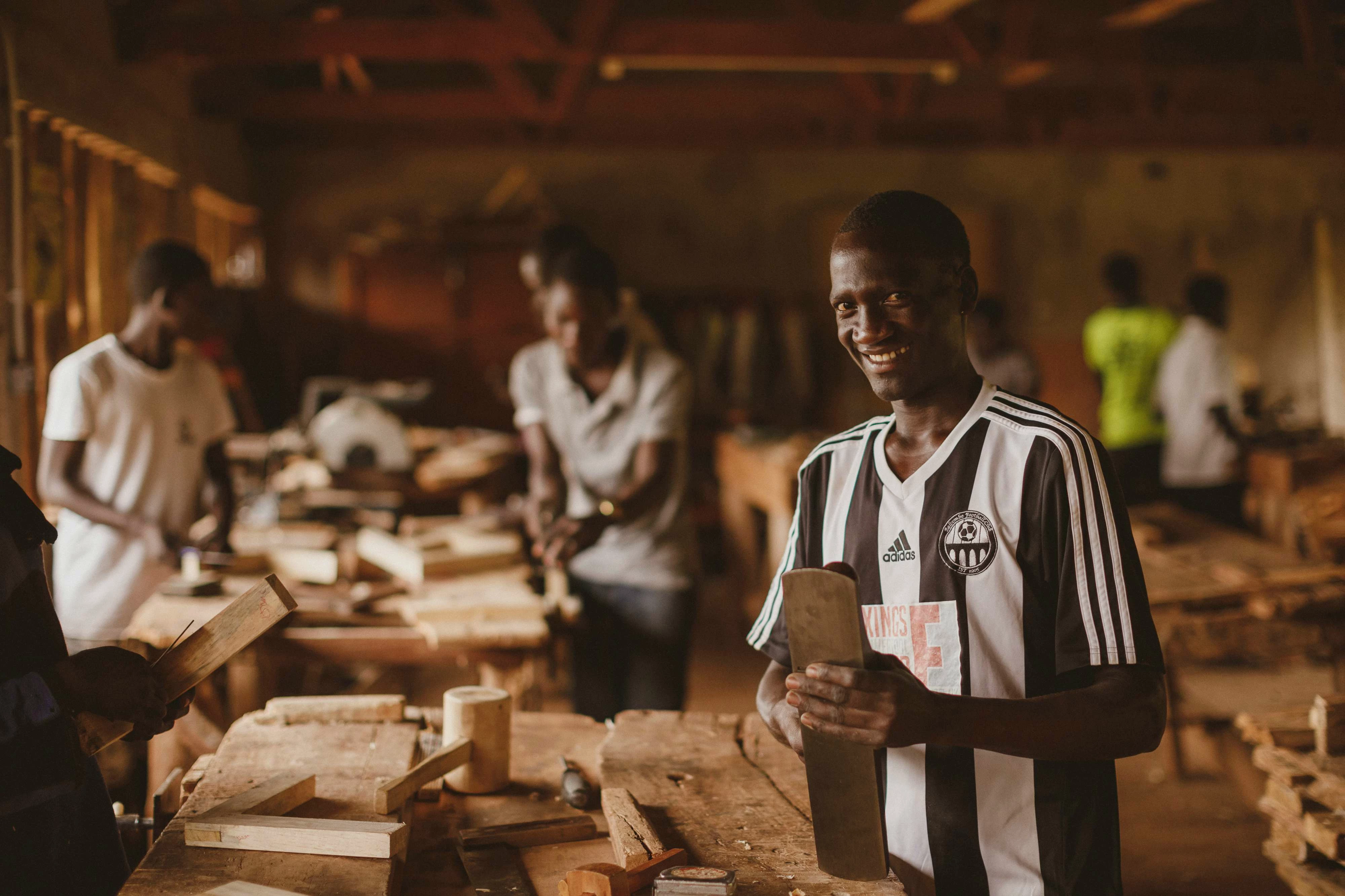 Young people at the Kira Farm Development Centre in Uganda using tools given to them by Amigos