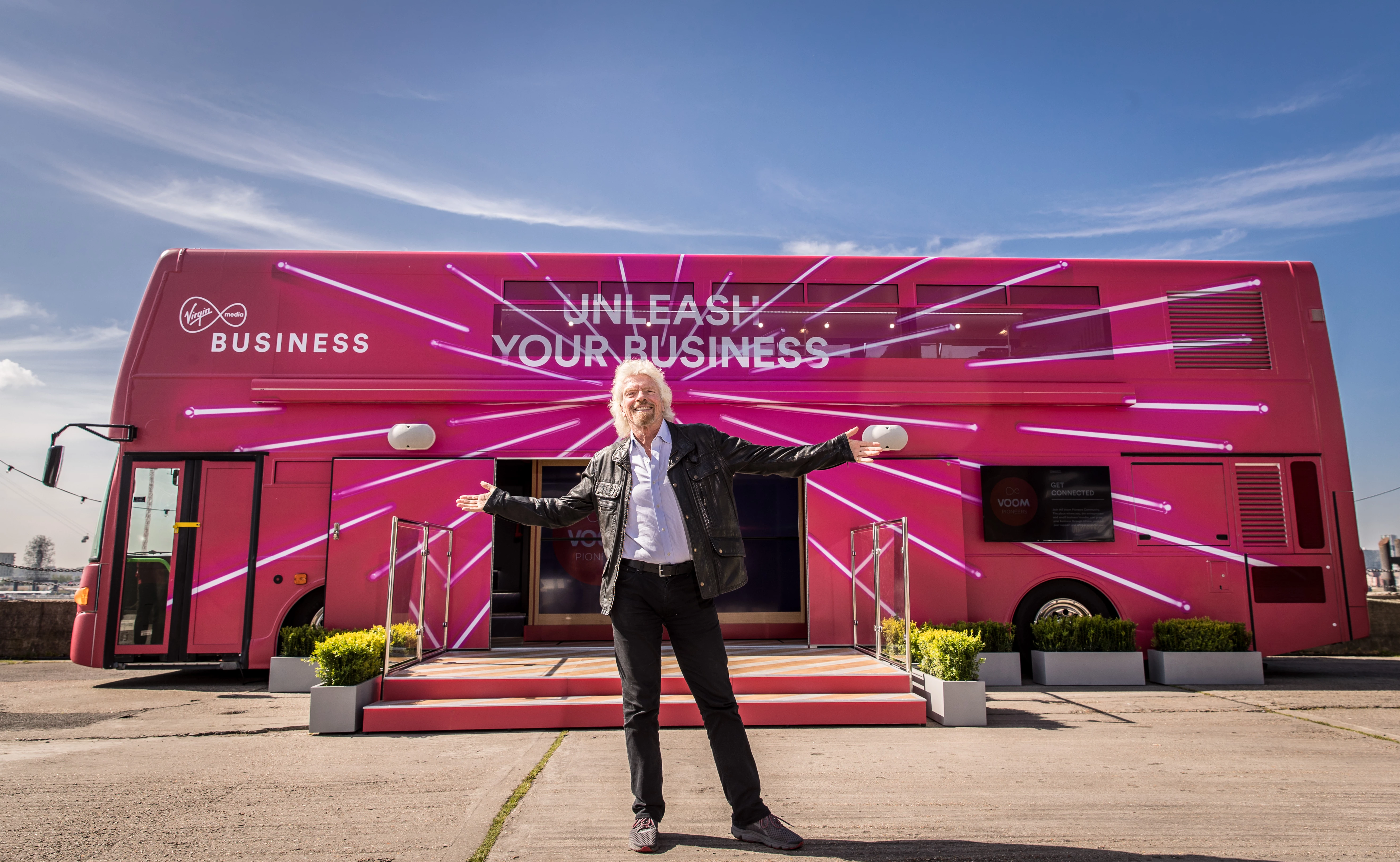 Richard Branson in front of the Voom bus.