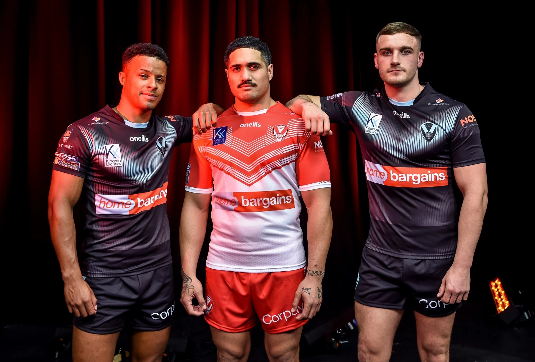 Saints stars Regan Grace, Sione Mata’utia and Matty Lees wearing St Helens’ 2022 home and away kits