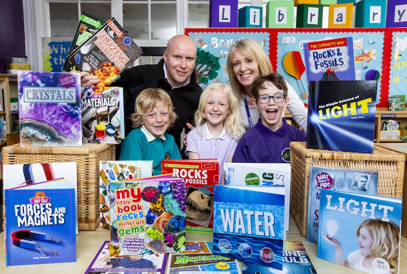 Airdale Chemical's Daniel Marr with school librarian Mrs Broughton and pupils at Sutton in Craven Community Primary School