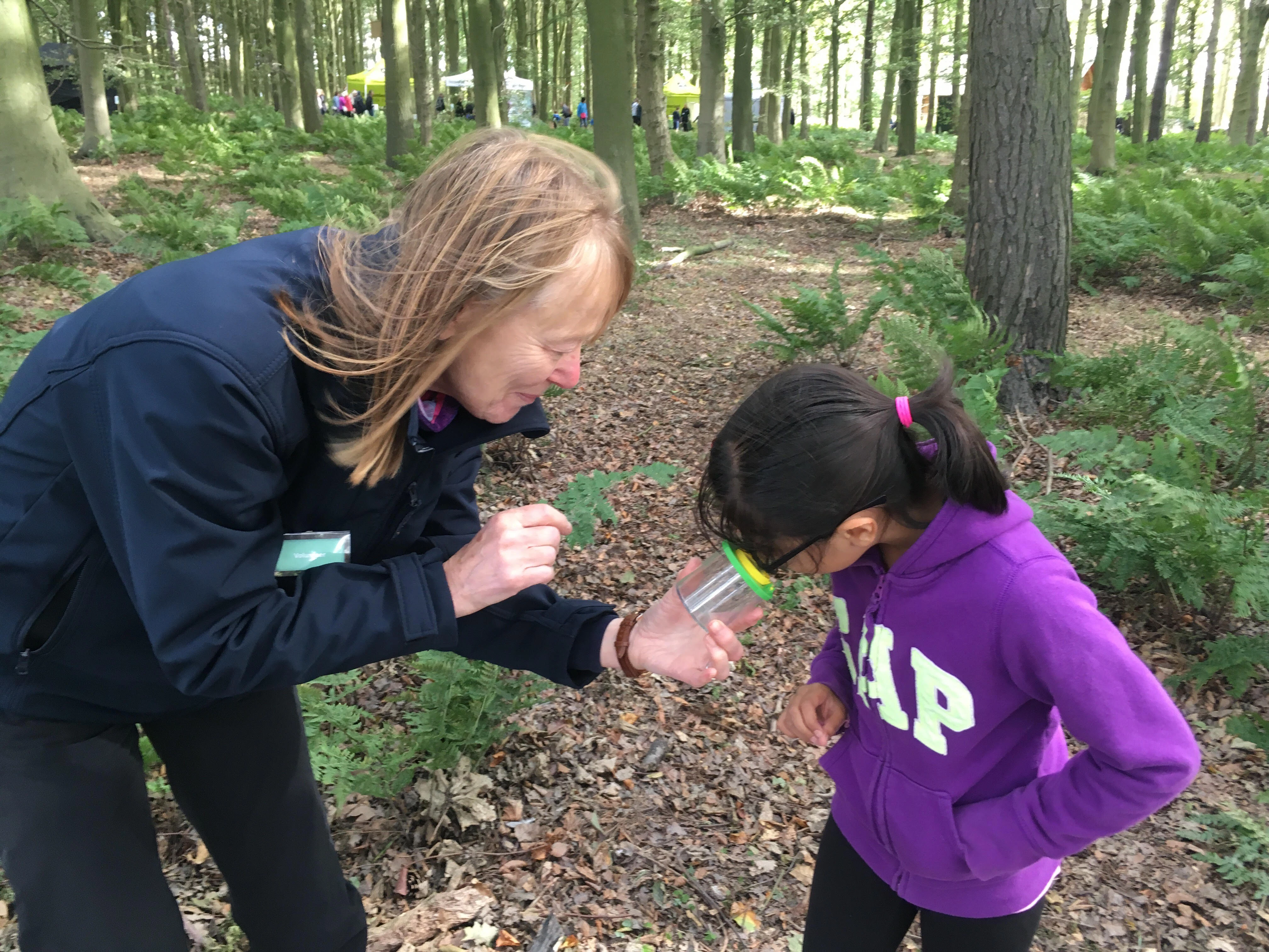 Liz Richmond Northumberland Wildlife Trust volunteer with young mini beast hunter