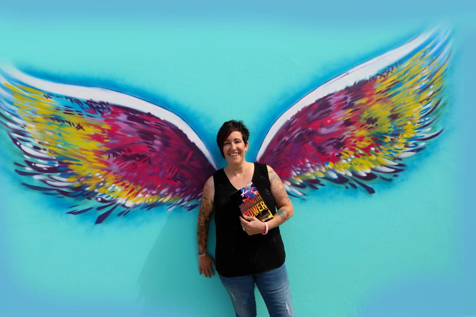 Jo Gilbert with her book, Strength and Power