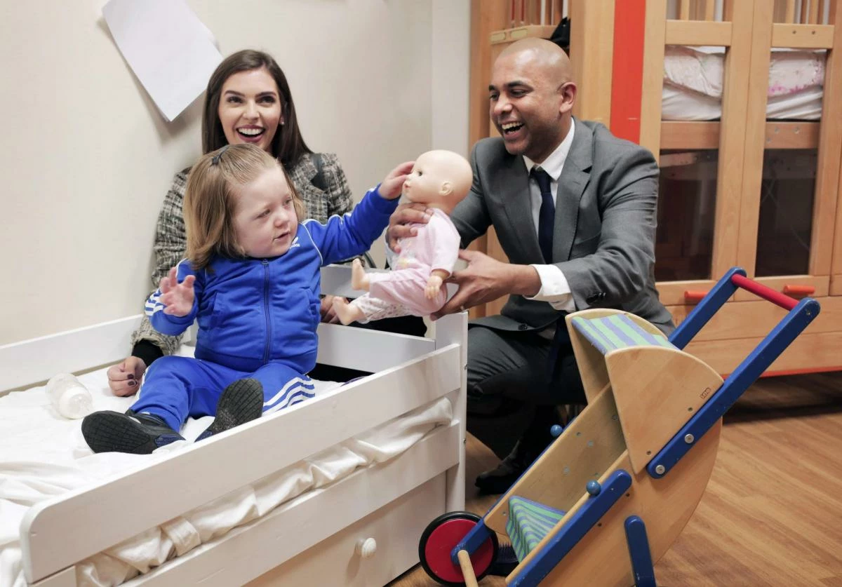 Rebecca Patterson and Vik Kumar with the children at Zoes Place Babys Hospice