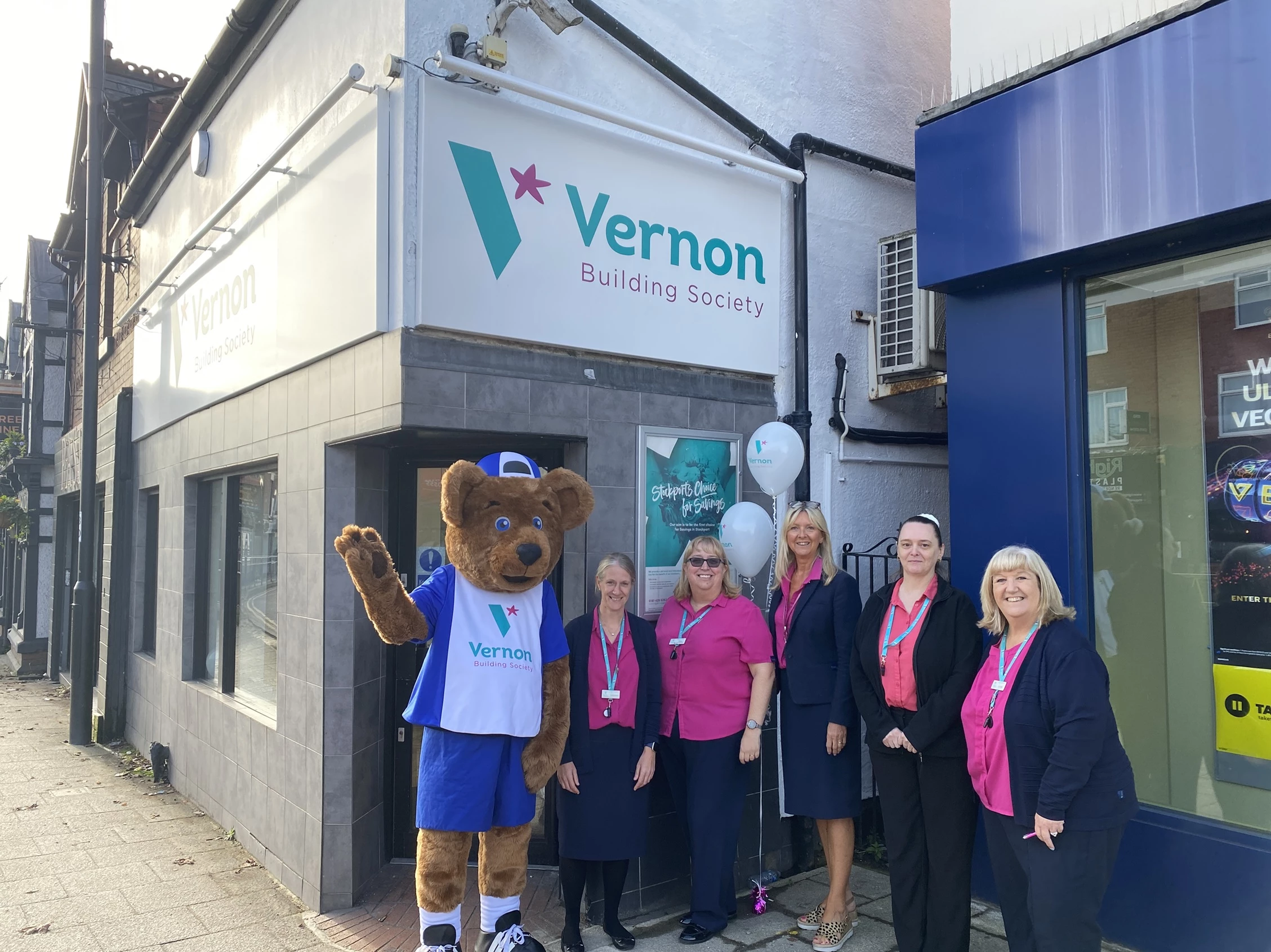 Staff from Vernon Building Society celebrate the refurb of thir Hazel Grove branch with Vernon Bear