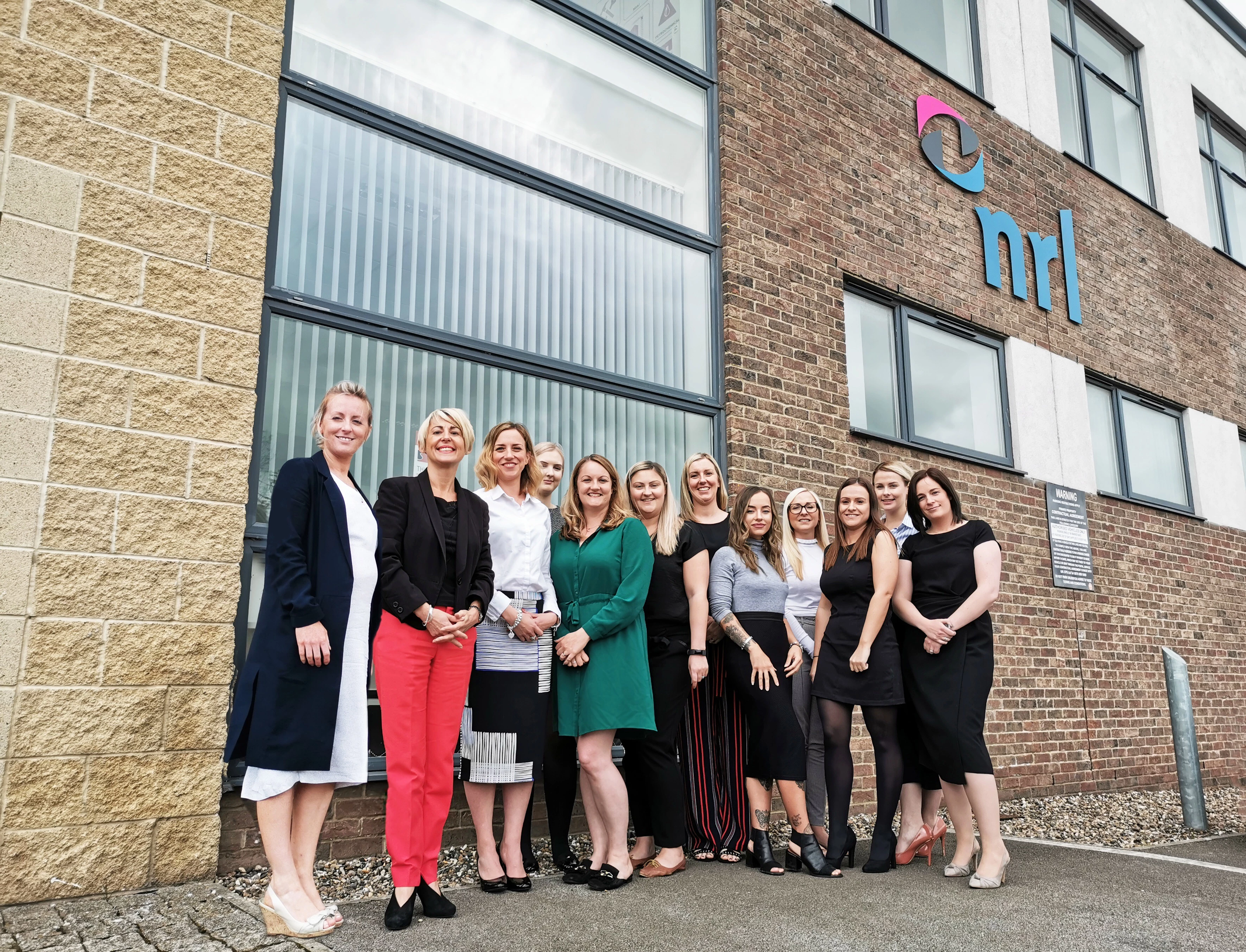  Adderstone Group’s Commercial Estate’s Manager, Amy Riley with the NRL team outside their new premises.