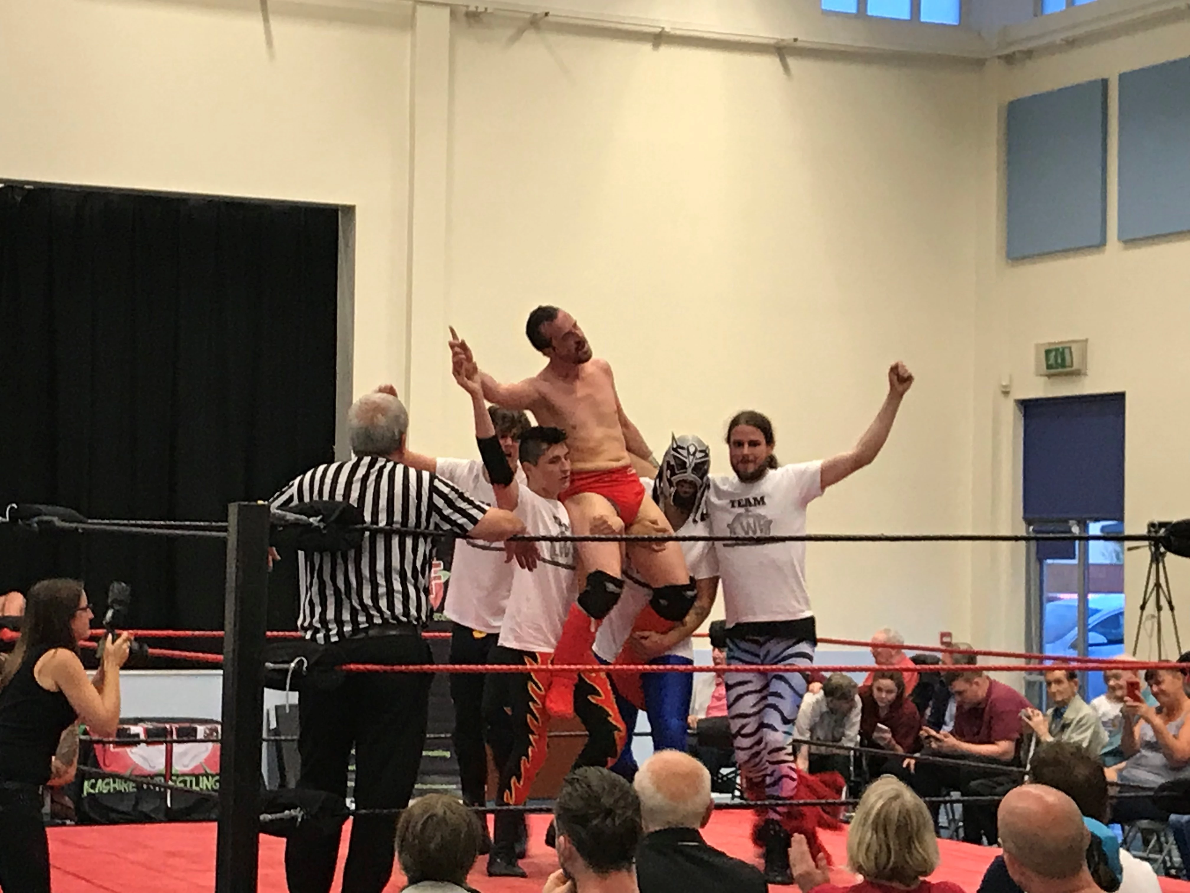 Wrestlers from The Lancashire Wrestling Federation celebrate a successful take down