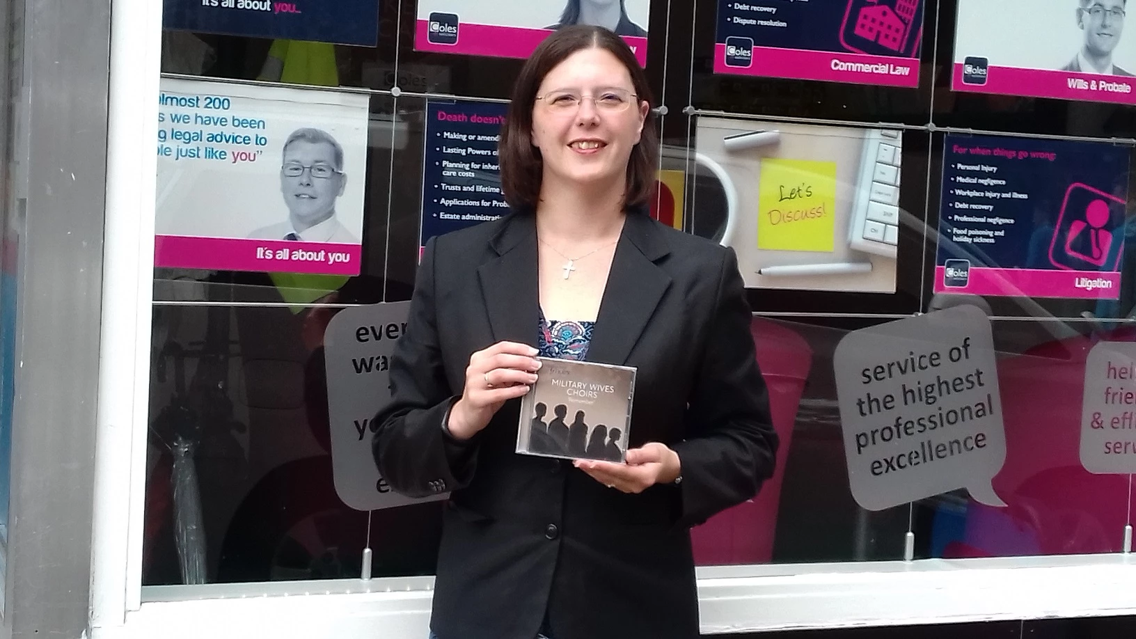 Emma Ladd of Coles Solicitors with the Military Wives' Choir album